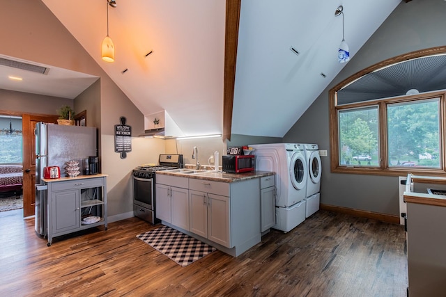 laundry area with sink, dark hardwood / wood-style floors, and washing machine and clothes dryer