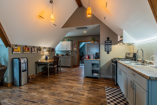 kitchen featuring sink, lofted ceiling with beams, pendant lighting, and gas stove