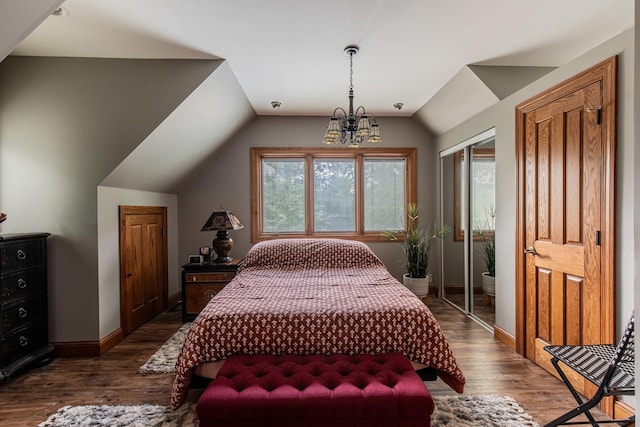 bedroom featuring vaulted ceiling, a chandelier, and dark hardwood / wood-style floors