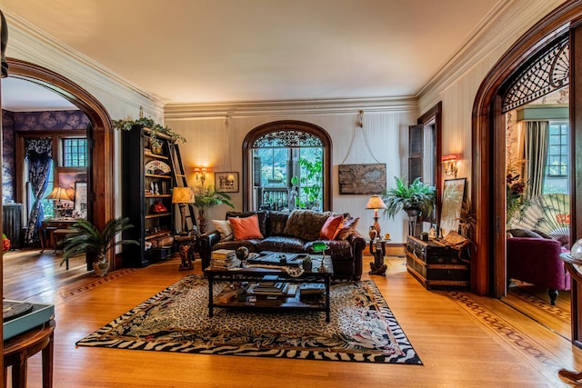 sitting room featuring wood-type flooring and ornamental molding