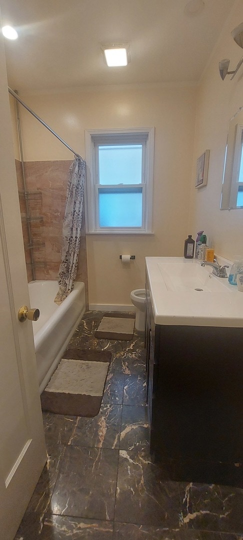 full bathroom featuring shower / tub combo, tile patterned flooring, toilet, and vanity