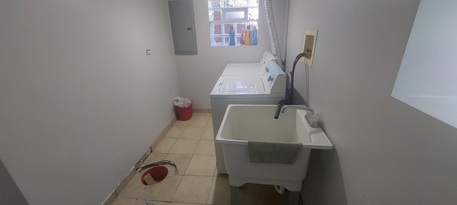 washroom with electric panel, washing machine and dryer, sink, and light tile patterned floors