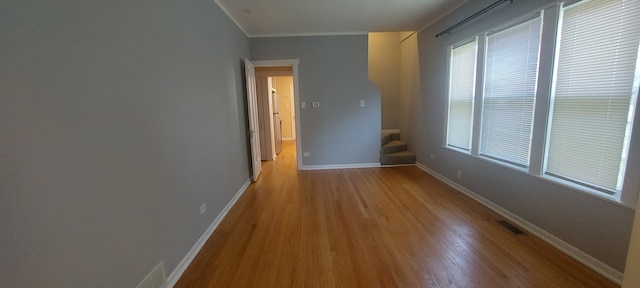 interior space featuring hardwood / wood-style floors and ornamental molding