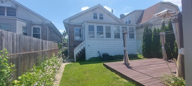 rear view of property with a lawn