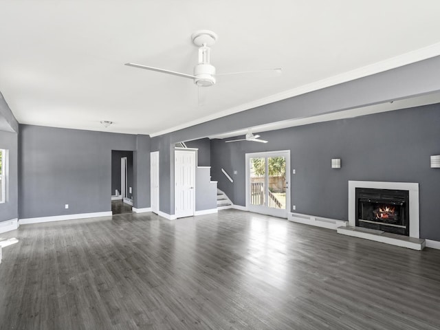 6602 Kennedy Ave, Hammond, IN 46323 - unfurnished living room with ceiling fan, a lit fireplace, stairway, and dark wood-style flooring