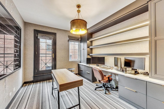 carpeted home office featuring built in desk