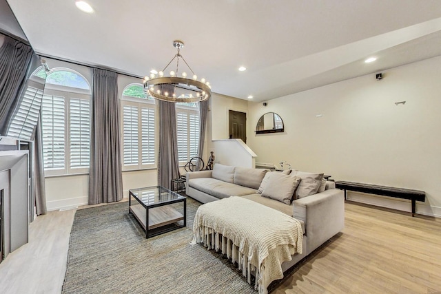 living room with a chandelier and light hardwood / wood-style flooring