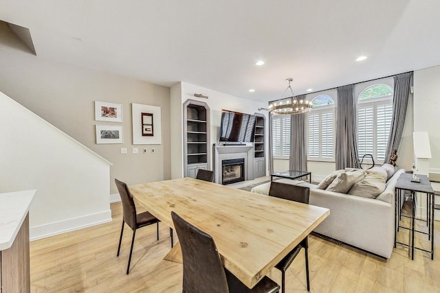 dining room with an inviting chandelier and light hardwood / wood-style flooring