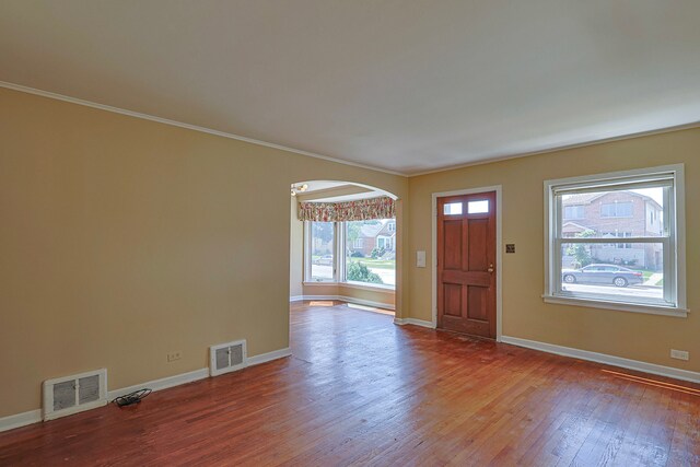 foyer with hardwood / wood-style flooring and crown molding