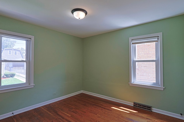 unfurnished room featuring dark wood-type flooring