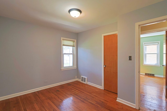 spare room with hardwood / wood-style flooring