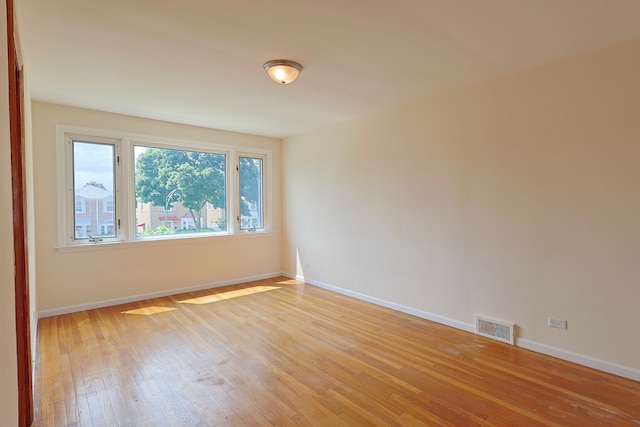 empty room with light hardwood / wood-style flooring