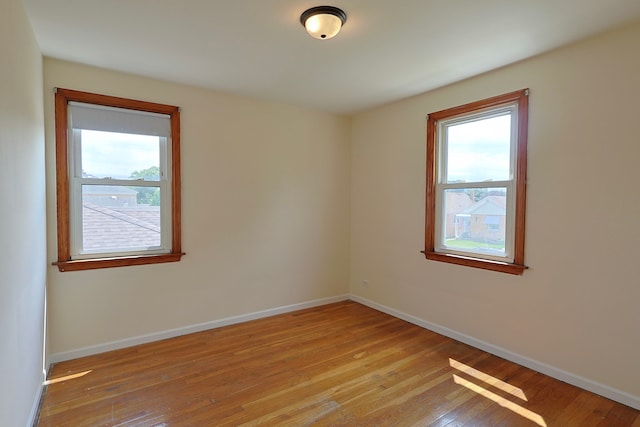 empty room with light hardwood / wood-style flooring