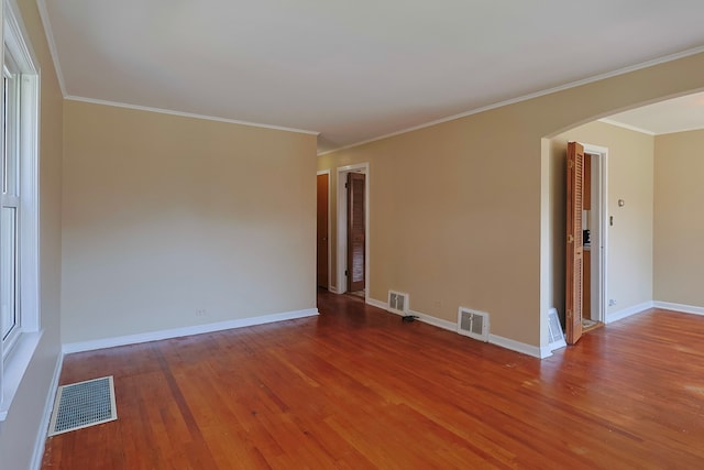 spare room featuring ornamental molding and hardwood / wood-style floors