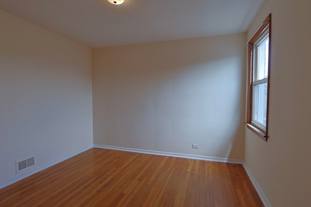 empty room with hardwood / wood-style floors