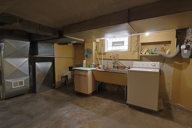 basement with sink and washer / dryer