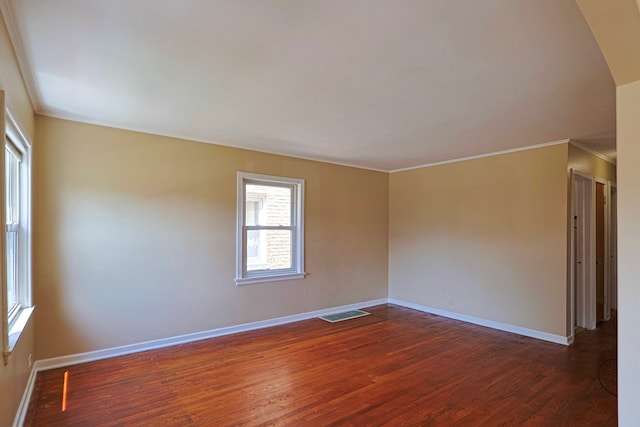 unfurnished room with dark hardwood / wood-style flooring and crown molding