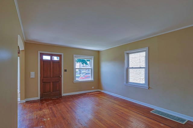 foyer entrance featuring wood-type flooring and ornamental molding