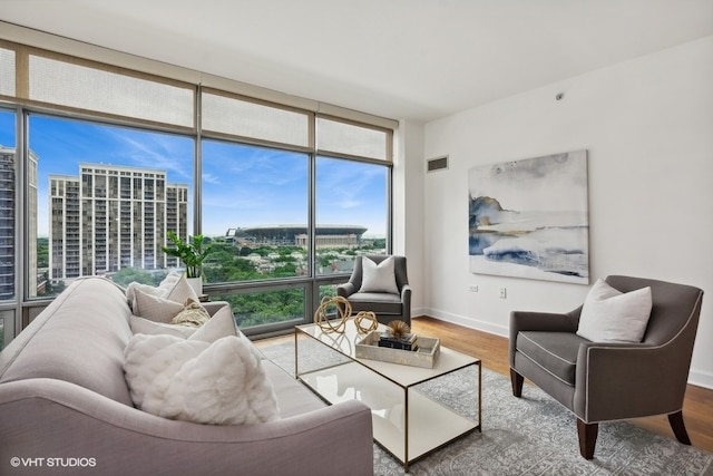 living room featuring a wall of windows and hardwood / wood-style flooring