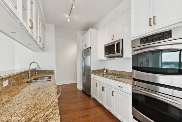 kitchen featuring light stone countertops, sink, appliances with stainless steel finishes, and white cabinets