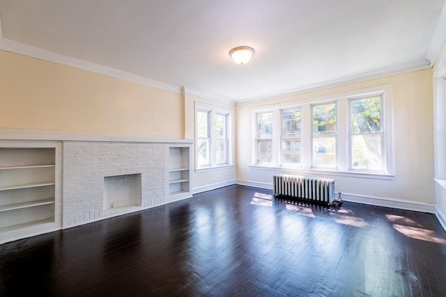 unfurnished living room with built in features, radiator heating unit, a fireplace, and dark wood-type flooring