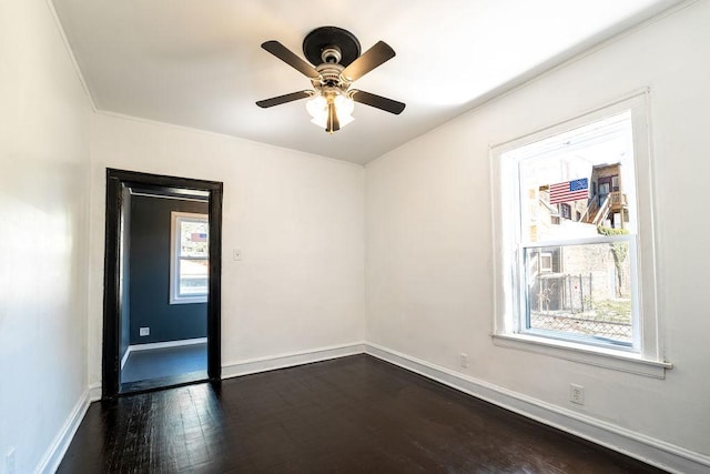 unfurnished room with dark hardwood / wood-style flooring, ceiling fan, and a healthy amount of sunlight