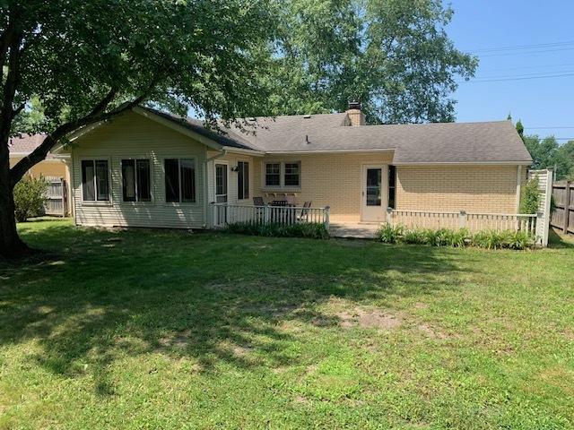 rear view of property with a lawn