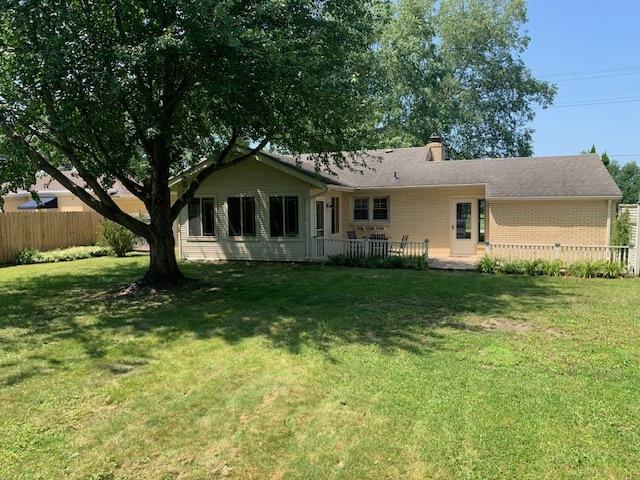 rear view of property with a yard