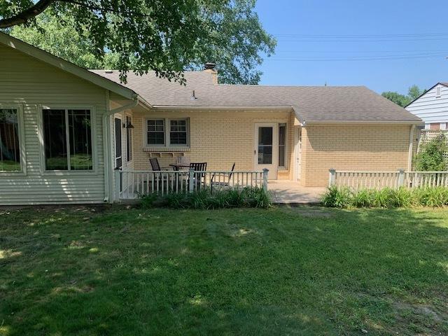 rear view of house with a patio and a yard