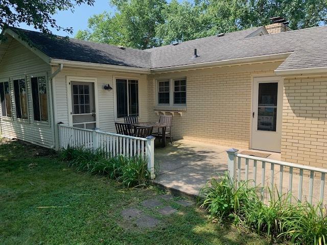 back of house with a lawn