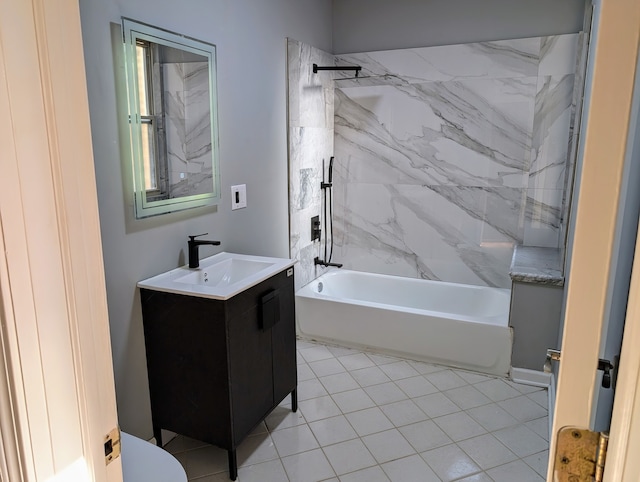 full bathroom featuring tiled shower / bath, vanity, toilet, and tile patterned flooring