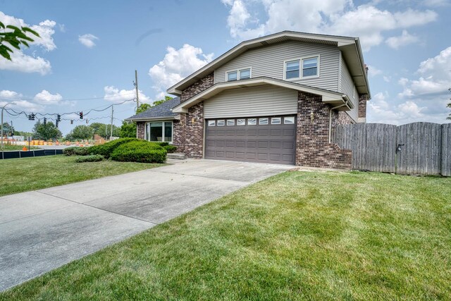 view of front property with a garage and a front lawn