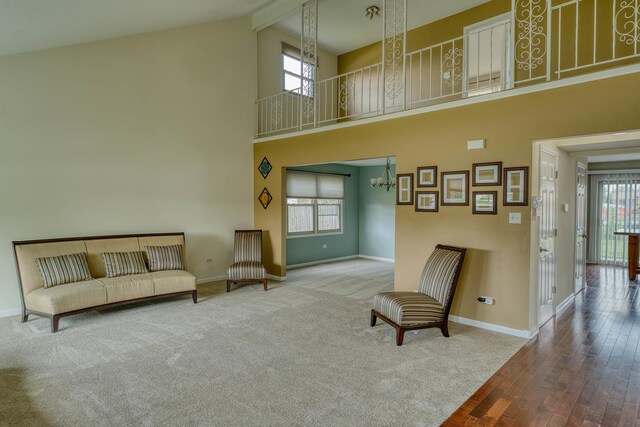 sitting room featuring high vaulted ceiling, beamed ceiling, hardwood / wood-style flooring, and a wealth of natural light