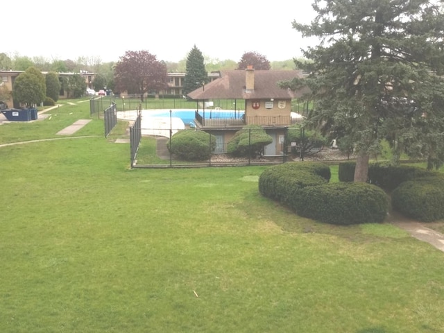 surrounding community with a pool and a lawn