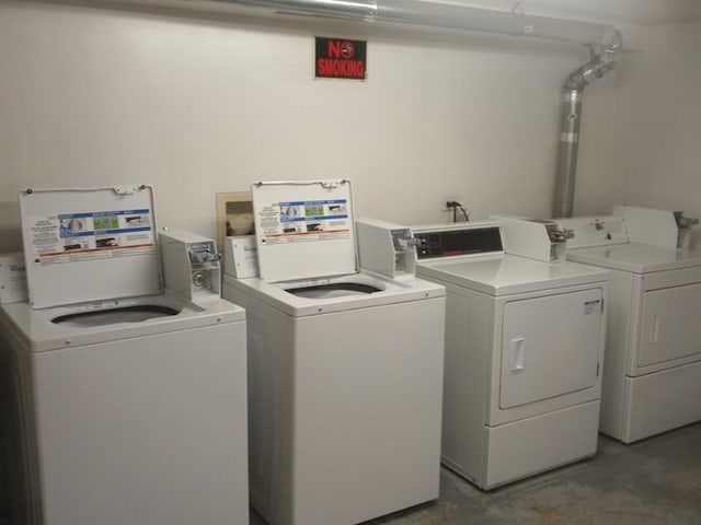 clothes washing area with washing machine and clothes dryer