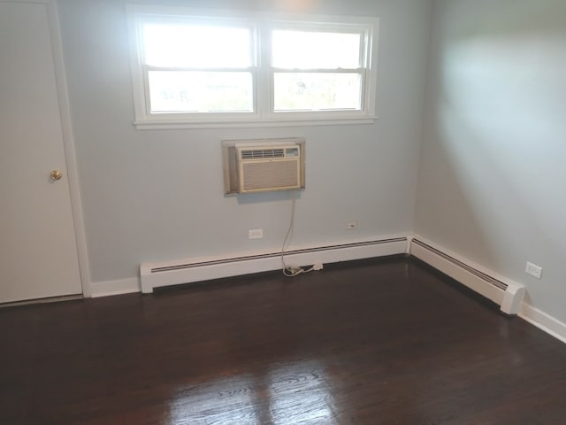 empty room with dark hardwood / wood-style flooring and a wall mounted AC