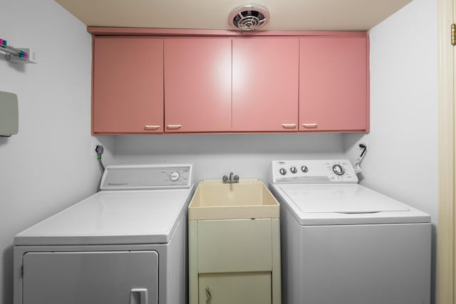 washroom with cabinets and washer and clothes dryer