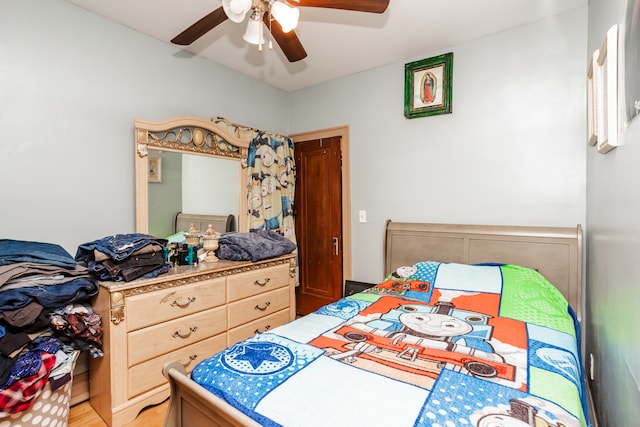 bedroom featuring light hardwood / wood-style floors and ceiling fan