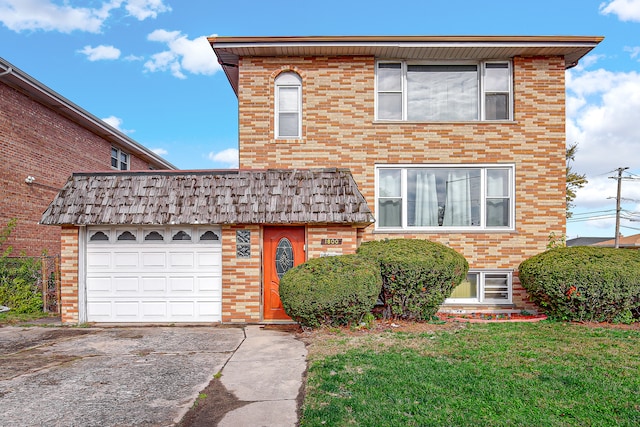 front of property featuring a front yard and a garage