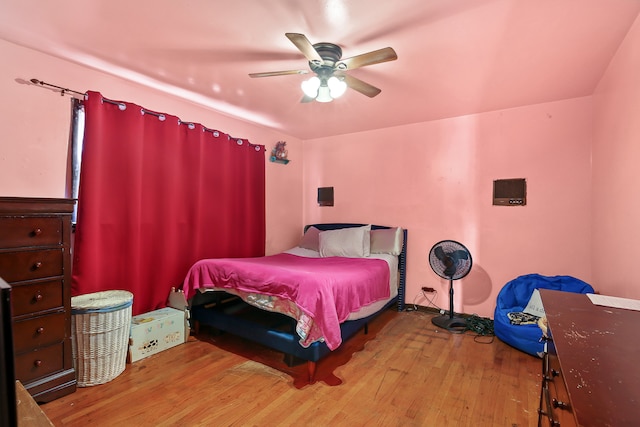 bedroom with wood-type flooring and ceiling fan