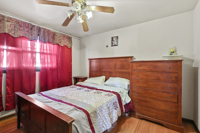 bedroom with hardwood / wood-style flooring and ceiling fan