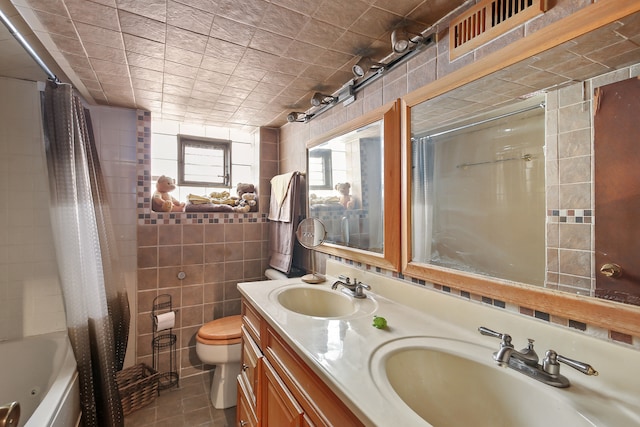 full bathroom with shower / bath combo, toilet, tile patterned flooring, vanity, and tile walls