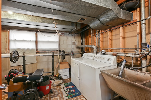 washroom with washer and dryer and sink