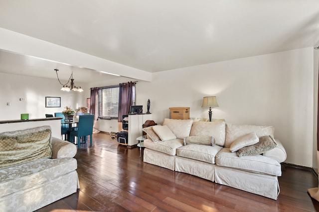 living room with an inviting chandelier and dark hardwood / wood-style flooring