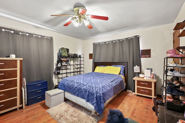 bedroom with light hardwood / wood-style floors and ceiling fan