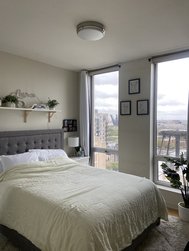 bedroom with hardwood / wood-style floors and multiple windows