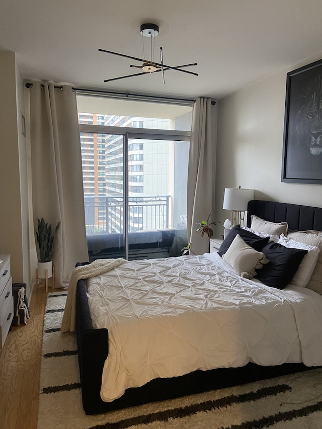 bedroom featuring ceiling fan and access to exterior