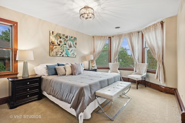 bedroom with visible vents, baseboards, carpet flooring, and a baseboard radiator