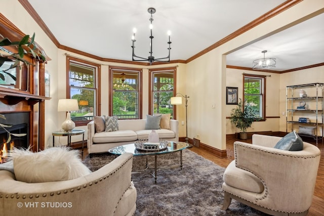 living room with crown molding, wood finished floors, and a chandelier