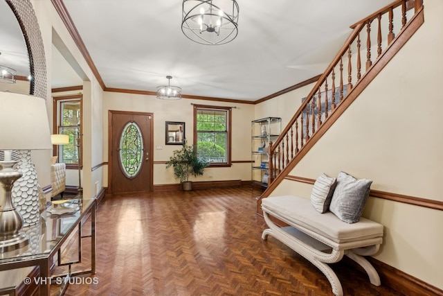 entryway with a wealth of natural light, baseboards, and a chandelier